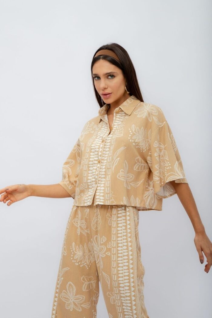 Conjunto Flora contém calça pantalona com elástico no cós e bolsos laterais. A camisa cropped com botões complementa o look, trazendo um toque moderno.